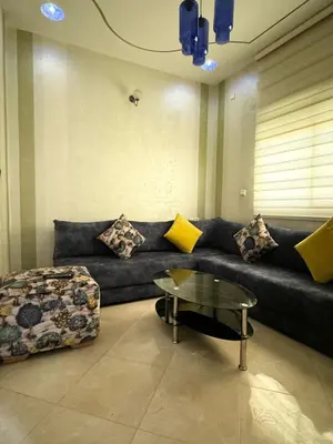 a living room with a couch and a coffee table at Appartement F in Fès