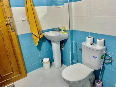 a bathroom with a toilet and a sink at Appartement F in Fès