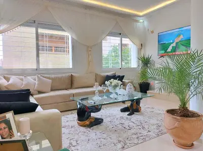 a living room with a couch and a table at villa saada in Fès