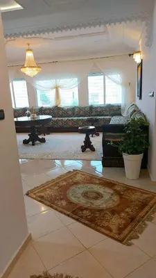a living room with a couch and a rug at villa saada in Fès