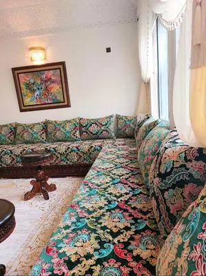 a living room with a couch and a window at villa saada in Fès