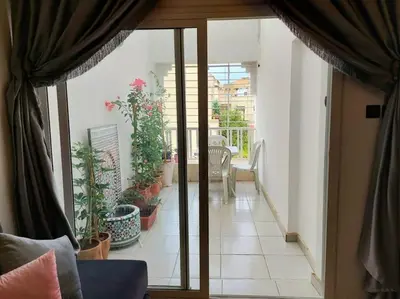 an open door to a balcony with potted plants at villa saada in Fès