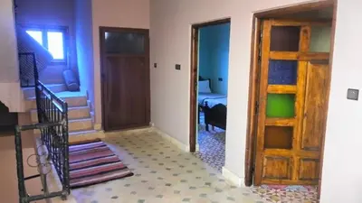 a hallway with a door and a room with a staircase at Kasbat Taslit chez l'habitant in Tabount