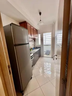 a kitchen with a stainless steel refrigerator at nice apaprt in Oulad Akkou