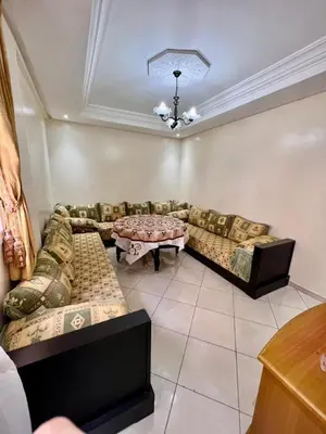 a living room with a couch and a table at nice apaprt in Oulad Akkou