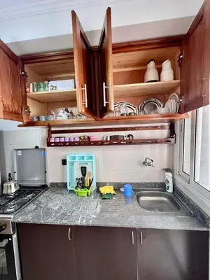 a kitchen with a counter top with a sink at nice apaprt in Oulad Akkou
