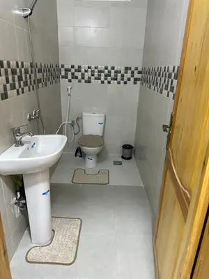 a small bathroom with a sink and a toilet at Al khaima in Oulad Akkou
