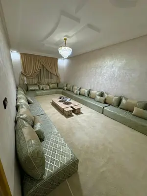 a living room with a couch and a table at Al khaima in Oulad Akkou