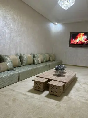 a living room with a couch and a coffee table at Al khaima in Oulad Akkou