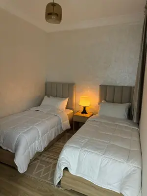 two beds sitting next to each other in a bedroom at Al khaima in Oulad Akkou