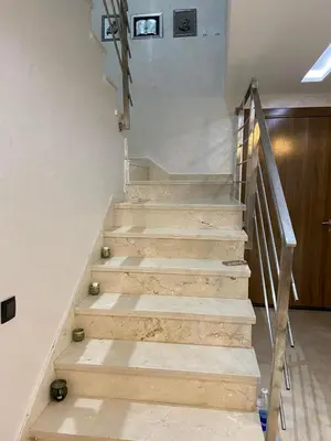 a staircase in a house with wooden steps at Duplex in Oulad Akkou