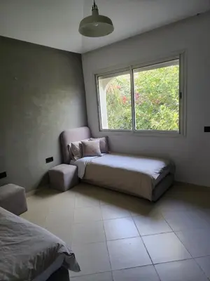 a bedroom with a bed and a window in it at Azure's House in Fès
