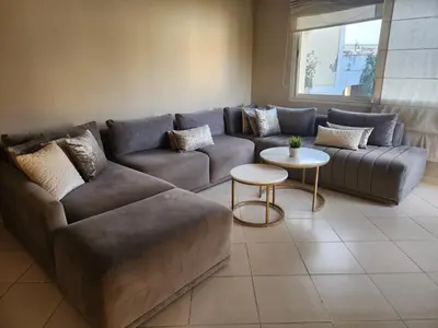 a living room with a couch and a table at Azure's House in Fès