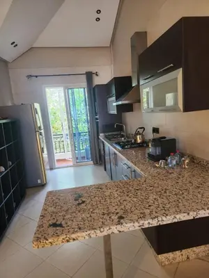 a kitchen with a granite counter top in a room at Azure's House in Fès