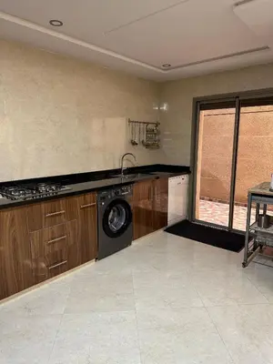 a kitchen with a washer and a washing machine in it at apartamente á fes in Fès