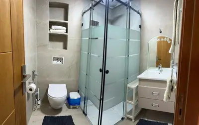 a bathroom with a shower and a toilet and a sink at apartamente á fes in Fès