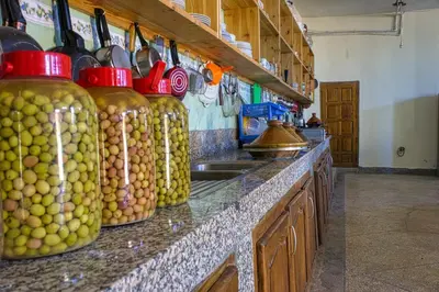 a kitchen with a counter with jars of olives at Lamtounipalace in Ouarzazate