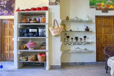 a shelf filled with dishes and baskets on a wall at Lamtounipalace in Ouarzazate