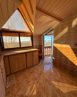 a large room with a large window and a table at Espace vert Chalet familial à Azrou in Azrou