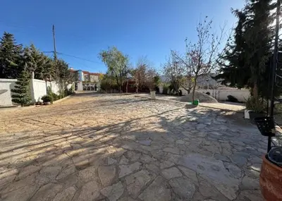an empty parking lot with a stone driveway at Espace vert Chalet familial à Azrou in Azrou