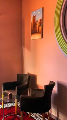 a room with two chairs and a glass table at Lmtounipalace in Ouarzazate