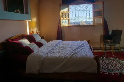 a bedroom with a bed and a window at Lmtounipalace in Ouarzazate