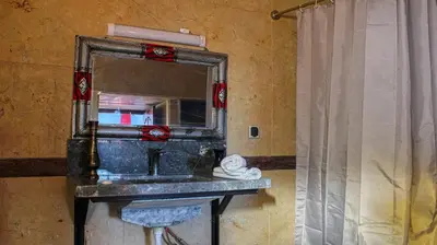 a bathroom with a sink and a mirror at Lmtounipalace in Ouarzazate