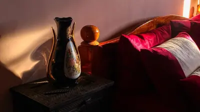 a vase sitting on a table next to a couch at Lmtounipalace in Ouarzazate