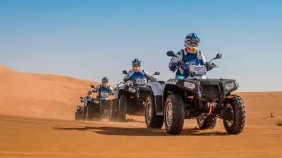 a group of people riding atvs in the desert at Your Desert Stay in Merzouga
