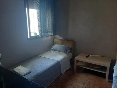 a small bedroom with two beds and a table at Chambre d'hôte jardins de Hamria in Meknès