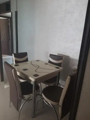 a table and chairs in a room with a table at Chambre d'hôte jardins de Hamria in Meknès