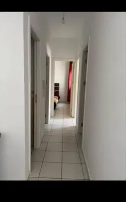 an empty hallway with white walls and white tile floors at Almaz in Fès