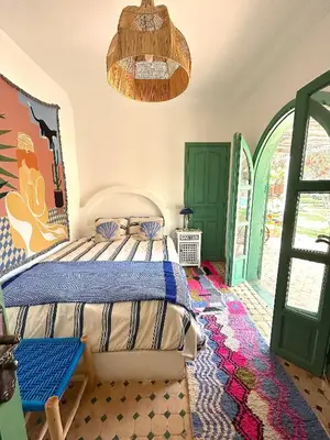a bedroom with a bed and a green door at Palais Julia in Chouiter