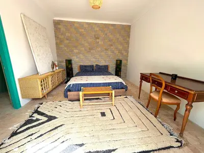 a bedroom with a bed and a desk and a piano at Palais Julia in Chouiter