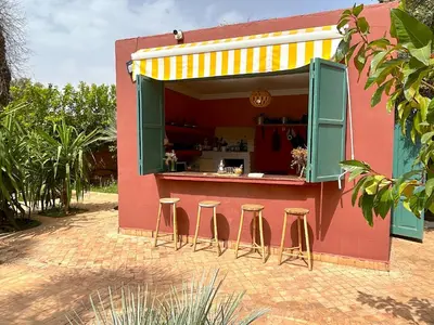 a building with a counter with stools in front of it at Palais Julia in Chouiter