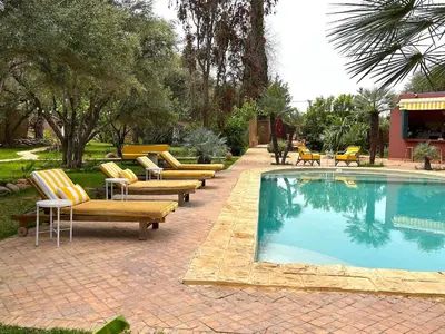 a group of lounge chairs and a swimming pool at Palais Julia in Chouiter