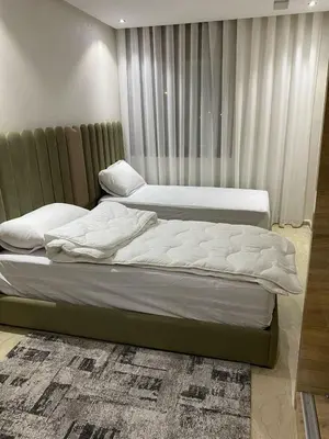 two twin beds in a bedroom with curtains at Apartment Ocean view in Oulad Akkou