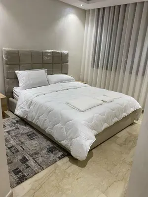 a bedroom with a large bed with white sheets at Apartment Ocean view in Oulad Akkou