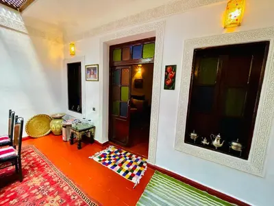 a living room with colorful glass doors and a floor at Dar Bladi -A Quiet Place to Reset in Fes in Fès