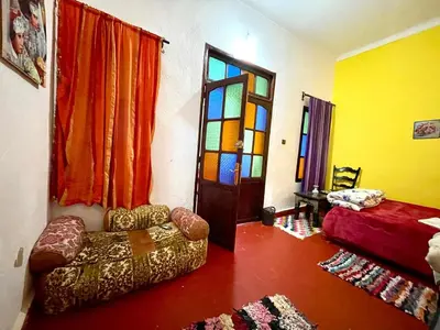 a living room with a couch and a stained glass door at Dar Bladi -A Quiet Place to Reset in Fes in Fès