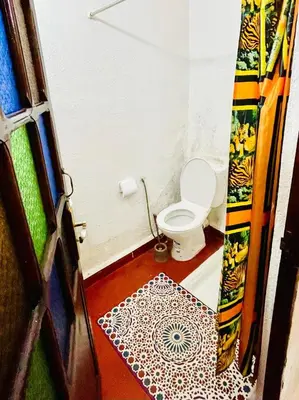 a bathroom with a toilet in a room at Dar Bladi -A Quiet Place to Reset in Fes in Fès