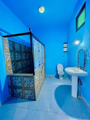 a blue bathroom with a sink and a toilet at Dar Bladi -A Quiet Place to Reset in Fes in Fès