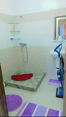a bathroom with a red tub and a sink at شقة اسراء قريبة من مطار مراكش المنارة الدولي in Oulad Akkou