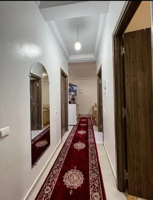 a hallway with a red rug on the floor at شقة اسراء قريبة من مطار مراكش المنارة الدولي in Oulad Akkou
