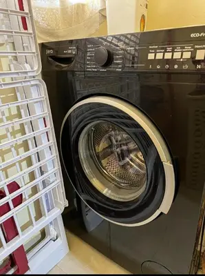 a washing machine with its door open in a room at شقة اسراء قريبة من مطار مراكش المنارة الدولي in Oulad Akkou