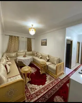 a living room with a couch and a table at شقة اسراء قريبة من مطار مراكش المنارة الدولي in Oulad Akkou