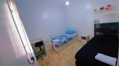 a small bedroom with a bed and a desk at شقة اسراء قريبة من مطار مراكش المنارة الدولي in Oulad Akkou