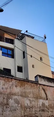 a tall white building sitting on top of a wall at Riad zineb in Fès