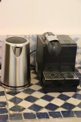 a coffee maker sitting next to a toaster on a counter at Riad zineb in Fès
