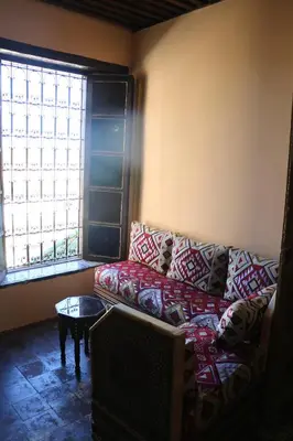 a living room with a couch and a window at Riad zineb in Fès